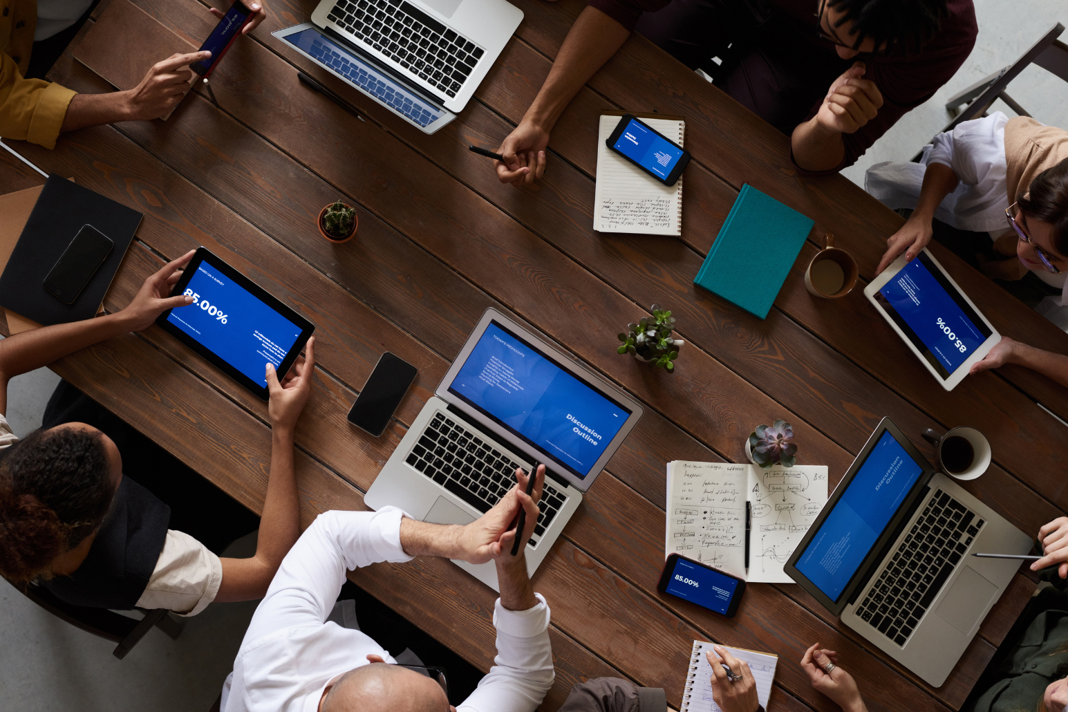 people with computers around a table